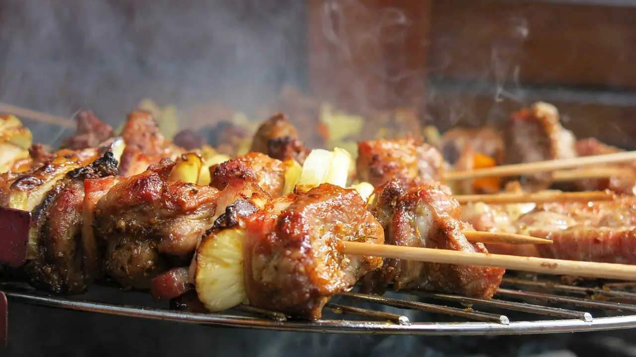 Kebabs cooking over the open charcoal grill